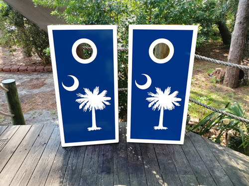 Cornhole boards with the SC logo on wood grain