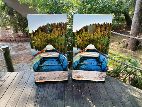 cornhole boards featuring a boat on a lake