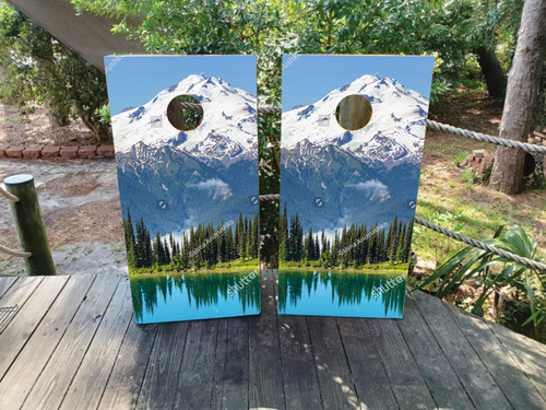 cornhole boards featuring a mountain lake