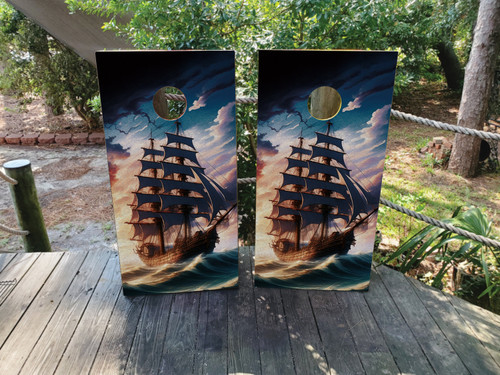 Cornhole boards featuring a pirate ship sailing in a dark cloudy sea