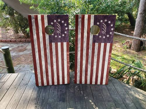 “Regulation 24×48″ professional cornhole boards featuring 13 Colonies historic flag and bold stars-and-stripes overlay with rustic woodgrain wrap printed on clear-coated birch”