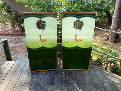 cornhole boards featuring a deer in a field