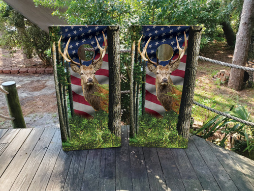 Cornhole boards with a deer in the woods and an american flag