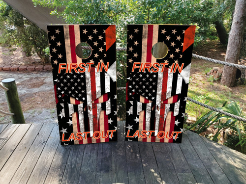 Cornhole boards featuring a thin red line flag with a skull that says first in last out