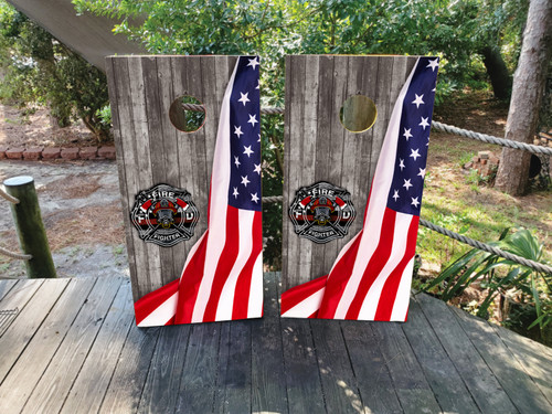 "Firefighter USA Flag Cornhole Boards Design 5 featuring regulation-size birchwood boards wrapped in rustic wood grain American flag design with firefighter emblem overlay and professional clear-coated finish"