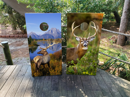 Cornhole boards featuring an elk and deer in the great outdoors
