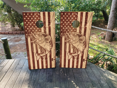 Cornhole boards featuring a wood grain USA American Flag and fish jumping out of the water