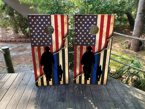 Cornhole boards featuring a USA/American flag with a thin blue line flag and the silhouette of an officer with a k9 dog