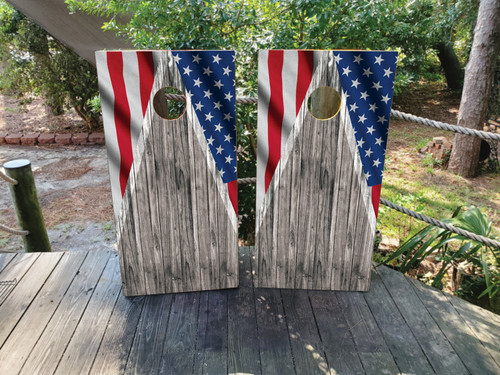 Cornhole boards featuring a wood grain background the American USA flag in the corners.