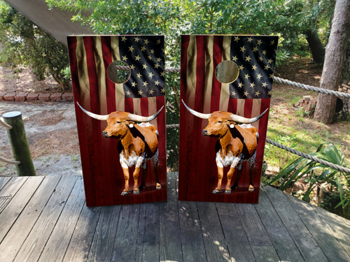 Cornhole boards featuring a waving USA flag and a longhorn cattle