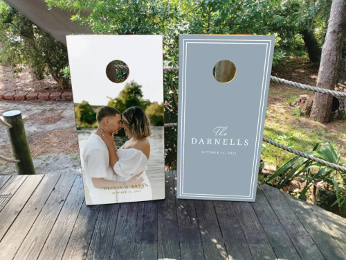 dusty blue cornhole boards with a wedding photo