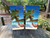 A scenic beach with a beach hammock on a set of cornhole boards