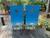 cornhole boards featuring beach chairs with drinks on the arm rests, overlooking the ocean