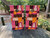 Cornhole boards featuring a totem pole and tiki pattern in pink and orange colors