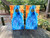Pair of vivid cornhole boards featuring a bold fire and ice design, with swirling flames on the top left and icy textures flowing down through the center and bottom right in a mirrored triangle formation.