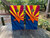 "Waving Arizona Flag Cornhole Boards featuring Arizona state flag design with dynamic waving effect and rustic wood background"