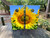 Cornhole boards featuring a bright yellow sunflower