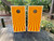 Cornhole boards featuring a sunburst orange and yellow pattern