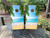 "Custom Beach Side Professional Cornhole Boards featuring personalized names with tropical beach scene and ocean view"
