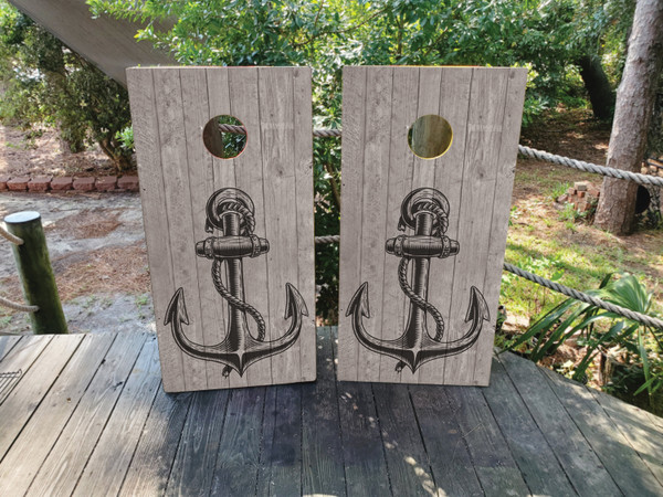 Nautical anchor on a distressed wood grain design for a cornhole board.