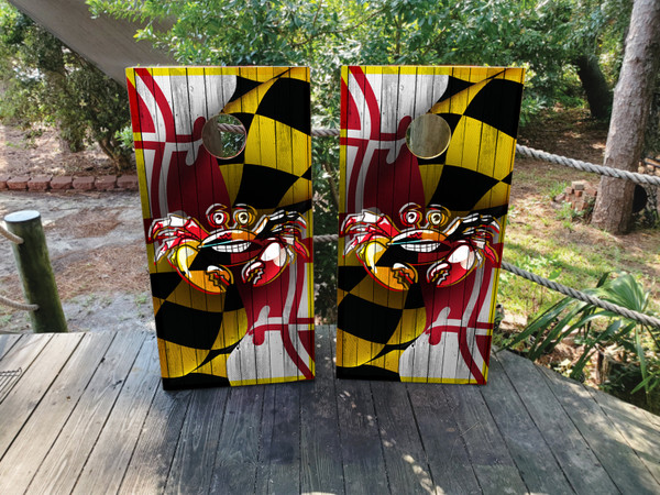 A crab on top of a baltimore maryland flag design on cornhole boards