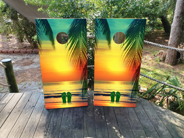 "Beach Sunset with Flip Flops Professional Cornhole Boards featuring tropical sunset scene with flip flop sandals and palm trees"