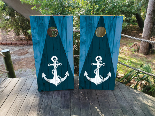 cornhole boards featuring a blue wood grain triangle and a nautical anchor