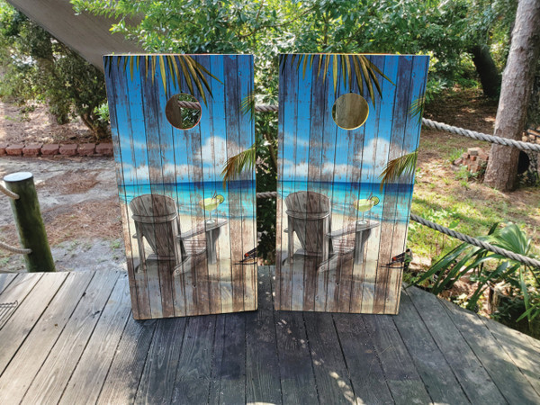 cornhole boards featuring a beach chair with a drinking overlooking the ocean on a distressed wood texture