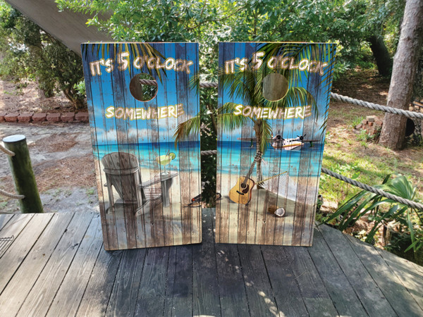 cornhole boards featuring a beach chair with a drink overlooking the ocean on a distressed wood texture