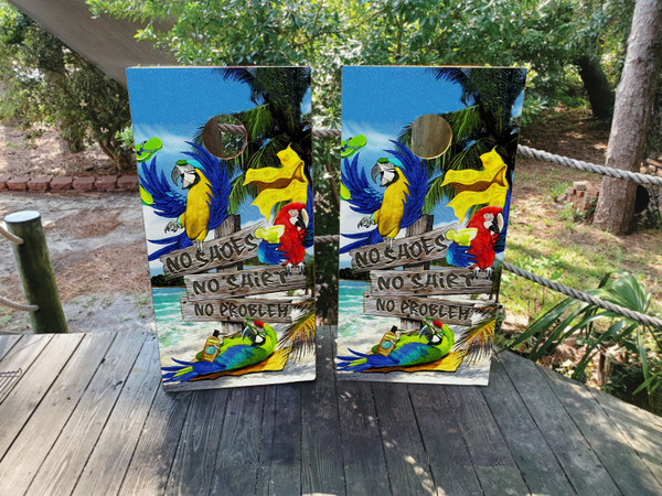 cornhole boards featuring parrots drinking on the beach, sitting on signs that say no shirt, no shoes, no service.