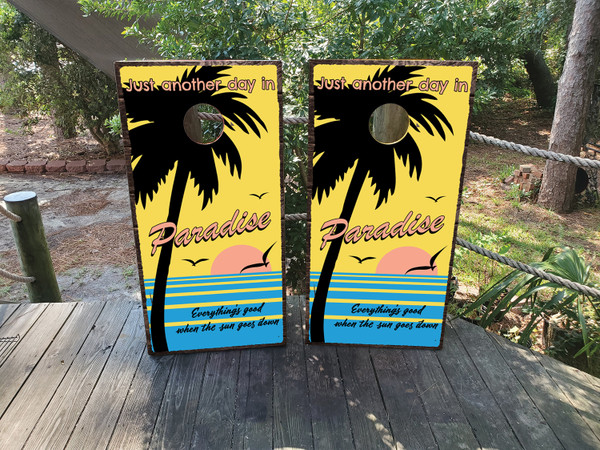 "Just Another Day in Paradise Professional Cornhole Boards featuring tropical beach scene with palm trees, sunset, and relaxing island vibe"
