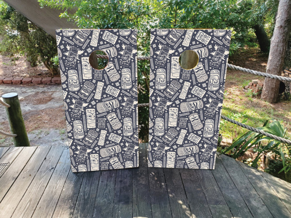 Cornhole boards featuring a totem pole pattern on a blue/gray background