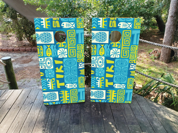 Cornhole boards featuring a totem pole and tiki pattern in blue and green colors