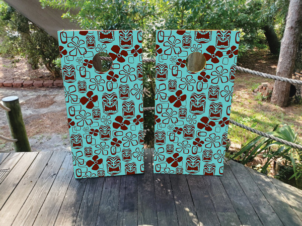 Cornhole boards featuring a totem pole and tiki pattern in blue and maroon colors