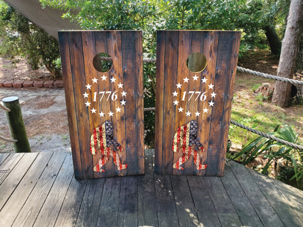 cornhole boards featuring big foot on a wood grain texture with a USA flag and 1776