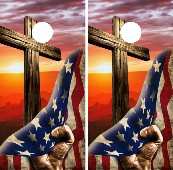 Cornhole boards featuring a hand pulling back a USA Flag to reveal a sunset and cross over a mountain landscape