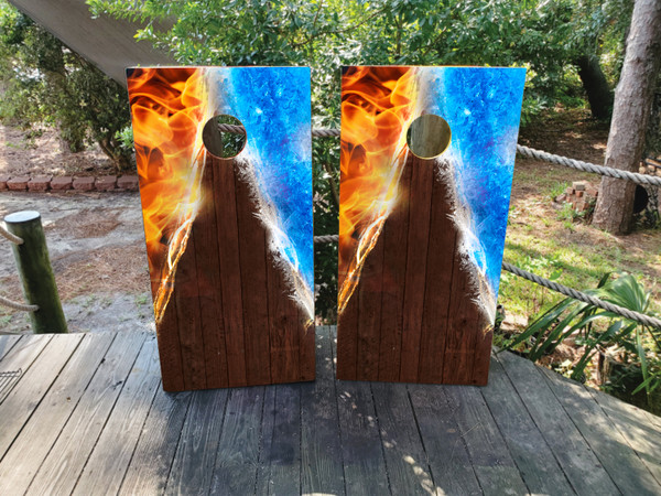 cornhole boards featuring a wood grain middle with fire on the left top and ice on the top right