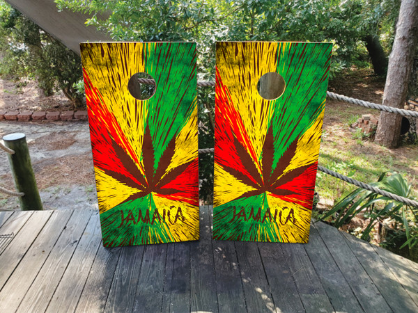 "Jamaican Flag Weed-Themed Cornhole Boards Design 2 featuring cannabis leaf with Jamaican flag colors and bold reggae-inspired design"