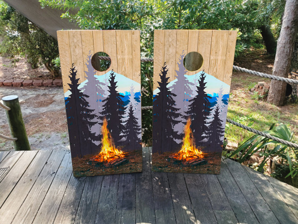 cornhole boards featuring a campfire in the woods