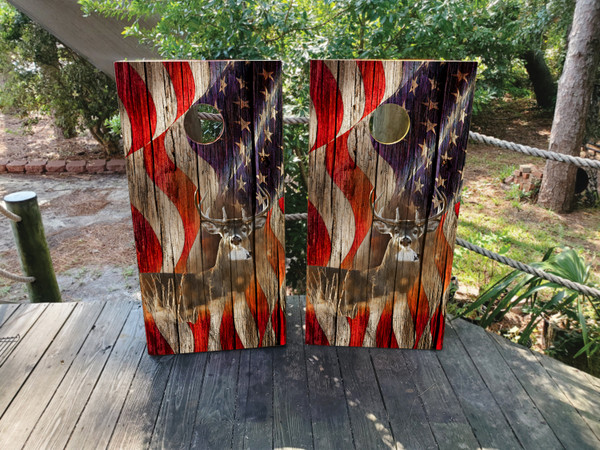 Cornhole boards with a deer in the woods and an american flag