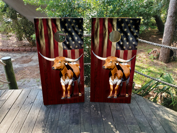 Cornhole boards featuring a waving USA flag and a longhorn cattle