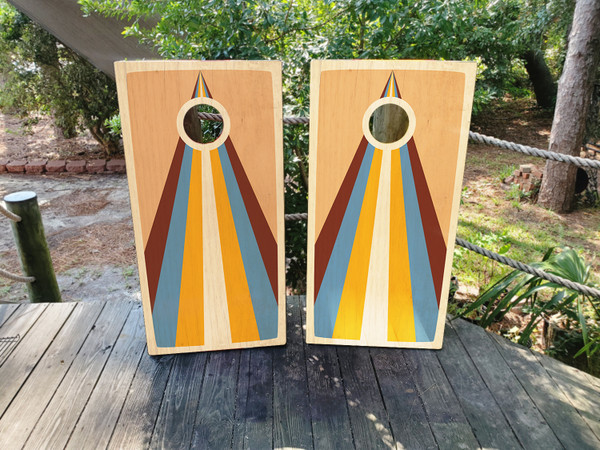 Cornhole boards featuring a colorful boho wood grain design