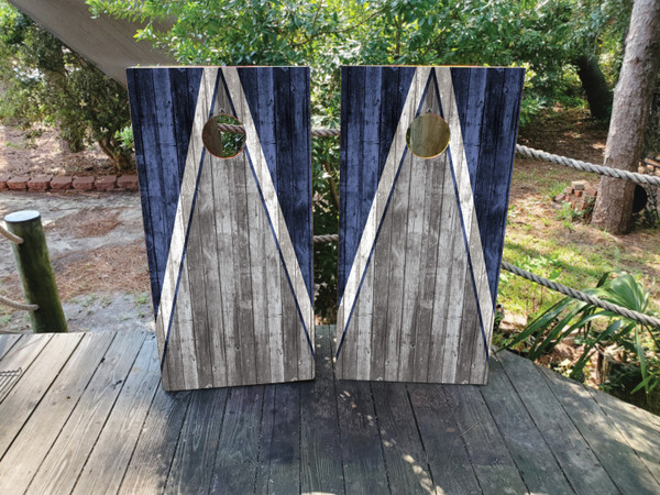 Cornhole boards featuring a natural wood grain in gray and navy