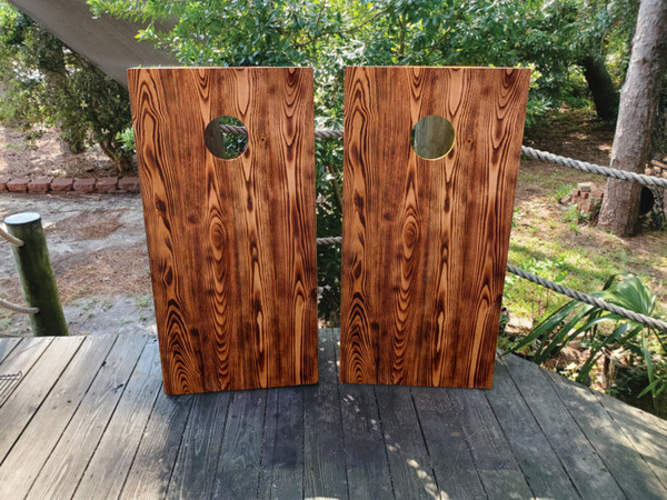 Cornhole boards featuring a burnt wood grain design