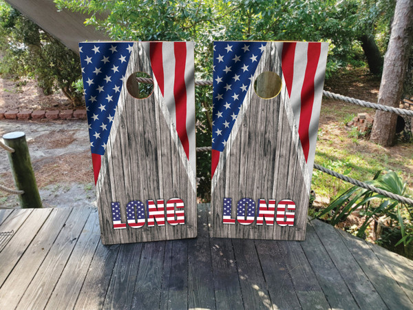 Custom Cornhole boards featuring a wood grain background the American USA flag in the corners.