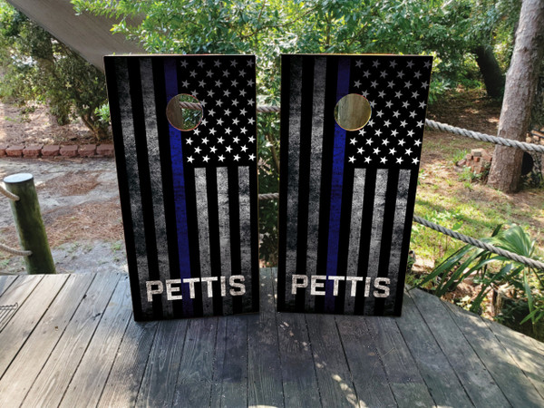 Custom cornhole boards featuring a black and white USA/American flag with a thin blue line