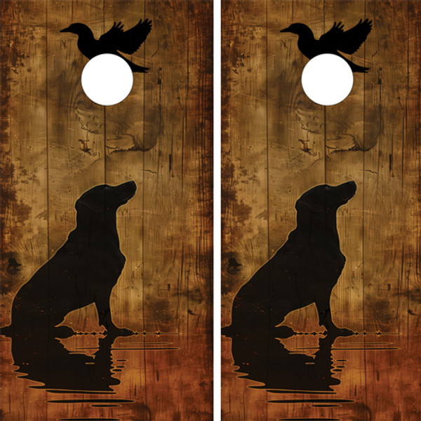 Two cornhole wraps featuring a rustic woodgrain background with the silhouette of a hunting dog sitting by water, its reflection visible, and a duck flying above, creating a hunting and outdoor-themed design