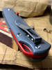 SMITH & SONS OX WITH GREY G-10 AND RED ANODIZED BACK SPACER AND THUMB STUD