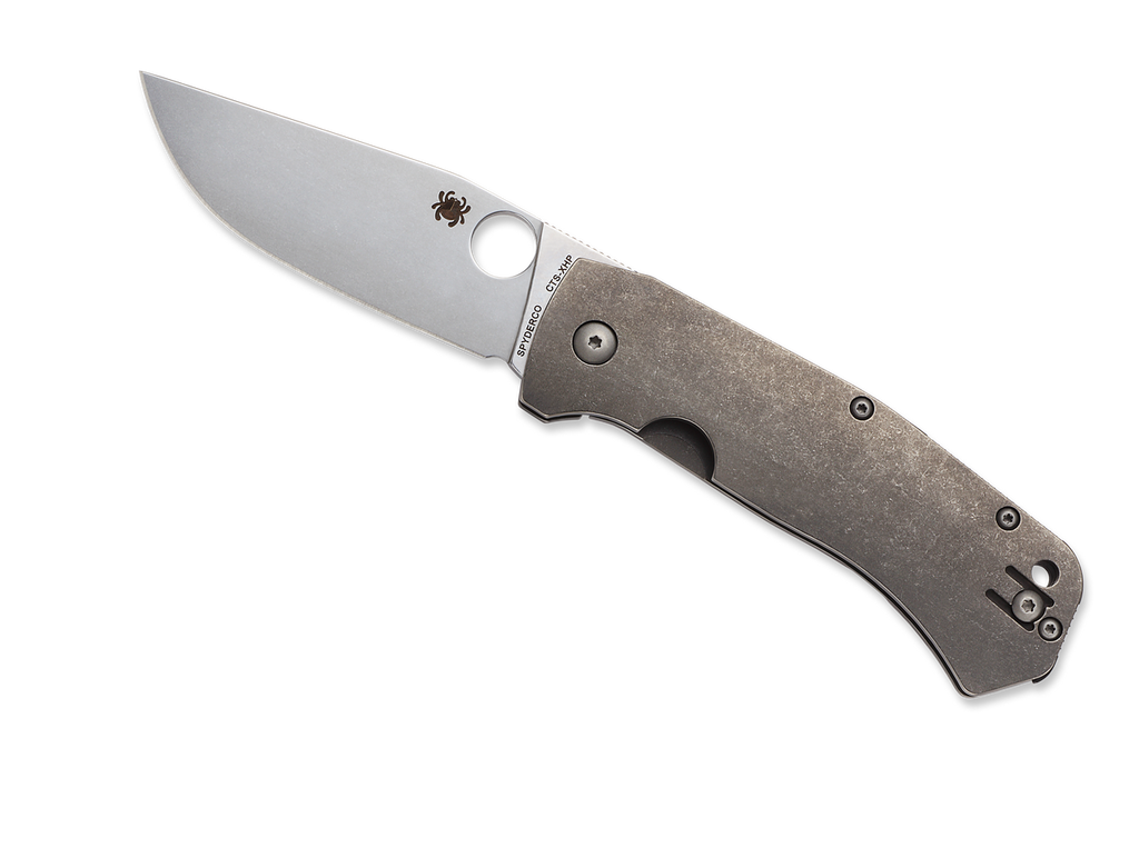 Spyderco Slysz Bowie folding knife with thumb hole - shown open presentation side.  Satin CTS-XHP stainless steel plain edge blade.  Titanium handle.  Model C186TIP.
For reference only.