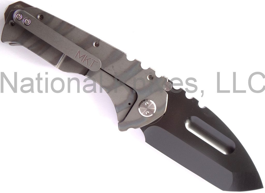 Medford Knives Praetorian folding knife with thumb groove - shown open lock side.  Black Oxide D2 steel plain edge blade.  Flame anodized titanium handle.  Model MK12DPT-03FL.
For reference only.